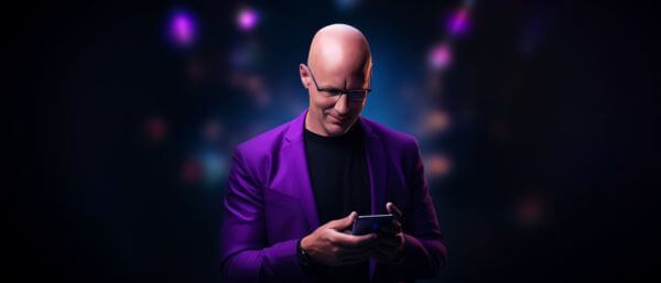 man_with_a_bald_head_with_an_iphone_in_his_hand